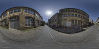 a 360 - ball camera photo of a street in front of an office building with graffiti all over it