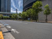 empty road with white lines on the streets of city area against cloudy blue sky on a sunny day