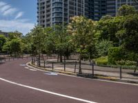 empty road with white lines on the streets of city area against cloudy blue sky on a sunny day