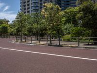 empty road with white lines on the streets of city area against cloudy blue sky on a sunny day