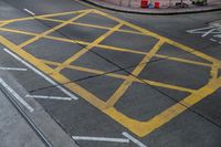 an intersection painted yellow with an old bus stop sign in the middle of the road