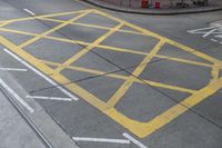 an intersection painted yellow with an old bus stop sign in the middle of the road