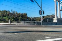 a traffic light at the intersection of an urban road and road that crosses over the freeway