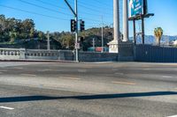 a traffic light at the intersection of an urban road and road that crosses over the freeway