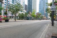 the empty road is very crowded with people walking on it, but many have been stopped