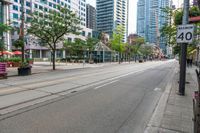 the empty road is very crowded with people walking on it, but many have been stopped