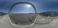 an fish - eye lens photograph shows two circular views, one on a skateboard and the other on a bridge