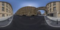 view of the street with some building and sky in it from a fish eye lens