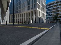 the empty street with bicycles parked in front of the buildings has a sign that says the library on it