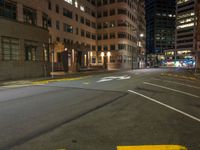 the city street is empty during the night time hours of construction work and business district