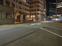 the city street is empty during the night time hours of construction work and business district