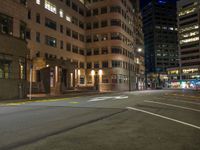 the city street is empty during the night time hours of construction work and business district