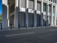 the empty street with bicycles parked in front of the buildings has a sign that says the library on it