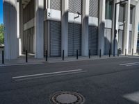 the empty street with bicycles parked in front of the buildings has a sign that says the library on it