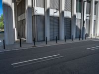 the empty street with bicycles parked in front of the buildings has a sign that says the library on it