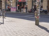 a street corner with an odd parking meter in it's front corner and people in the background