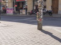 a street corner with an odd parking meter in it's front corner and people in the background