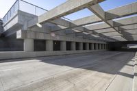 a empty street lined with lots of concrete overhangs in an industrial building structure