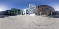 the 360 - view photograph shows a street, people and buildings in the background with sun peeking through windows