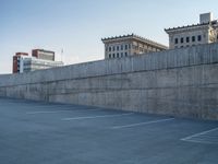 several large empty parking spaces in the city with buildings nearby in front of them -