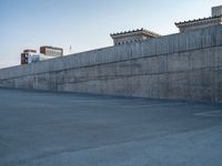 several large empty parking spaces in the city with buildings nearby in front of them -