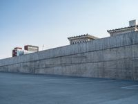 several large empty parking spaces in the city with buildings nearby in front of them -