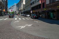 a bicycle is at the cross walk in a street with no cars on it as a building line