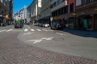 a bicycle is at the cross walk in a street with no cars on it as a building line