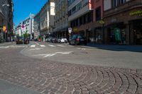 a bicycle is at the cross walk in a street with no cars on it as a building line