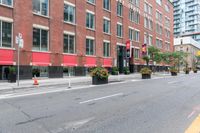 a city street next to two large buildings in a city intersection with no sidewalks on the streets