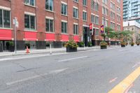 a city street next to two large buildings in a city intersection with no sidewalks on the streets