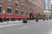 a city street next to two large buildings in a city intersection with no sidewalks on the streets