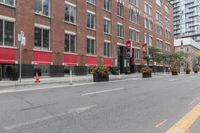 a city street next to two large buildings in a city intersection with no sidewalks on the streets