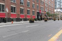 a city street next to two large buildings in a city intersection with no sidewalks on the streets