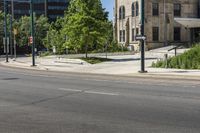 two cars driving down the road while some buildings look on in the distance or city