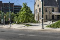 two cars driving down the road while some buildings look on in the distance or city