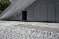 a walkway between two brick tiles and a gate outside a building with open bars on the walls