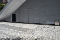 a walkway between two brick tiles and a gate outside a building with open bars on the walls