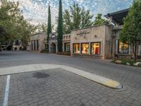 there is a parking meter in the middle of this courtyard area of a city setting