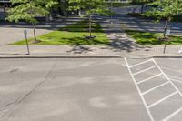 an empty parking lot and a few parking spaces on both sides of the street, in a city