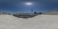 a picture of a skate park taken from the ground up by someone holding onto the board