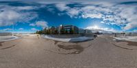 a fisheye lens shot of some skateparks and skating ramps in an urban setting