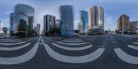 a distorted photograph shows buildings and traffic at an intersection and intersection that is empty with no cars