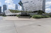 an empty parking lot has stairs in it's center with city buildings beyond it