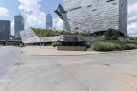 an empty parking lot has stairs in it's center with city buildings beyond it