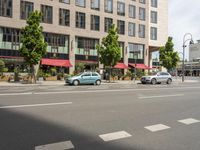 the car is parked on the side of the street beside the store's canopy