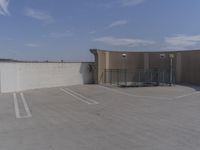 an empty parking lot in front of a building and sky background, showing how high the parking space could be