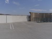 an empty parking lot in front of a building and sky background, showing how high the parking space could be
