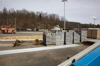 concrete blocks stacked in a truck parking lot near a fire engine pump in the parking lot