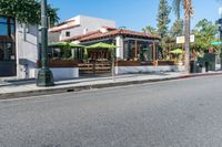 a picture of a corner that looks like the street with an umbrella stand in the middle